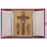 A gilt metal crucifix and figures in original leather case, and an olive wood crucifix, (2).