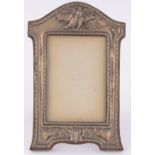 An Edwardian embossed silver fronted photo frame, Birmingham 1907, height 12cm.