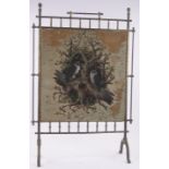 A Victorian brass framed firescreen, with inset beadwork owl design panel, height 93cm, width 62cm.