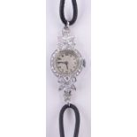 A lady's platinum and diamond set cocktail wristwatch, case width 18mm.