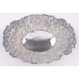 A Victorian oval silver bowl, with relief decorated flowers and scrolls by William Comyns,