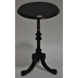 A Victorian ebonised and gilded tripod table, width 1'4", height 2'5".