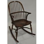 An 18th century style Windsor rocking chair with crinoline stretcher.