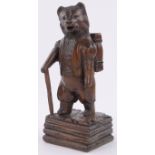 An Austrian carved stained wood hiking bear design vesta stand, height 25cm.