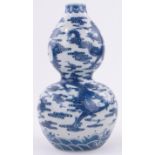 A Chinese blue and white porcelain double gourd vase, with painted dragon designs,