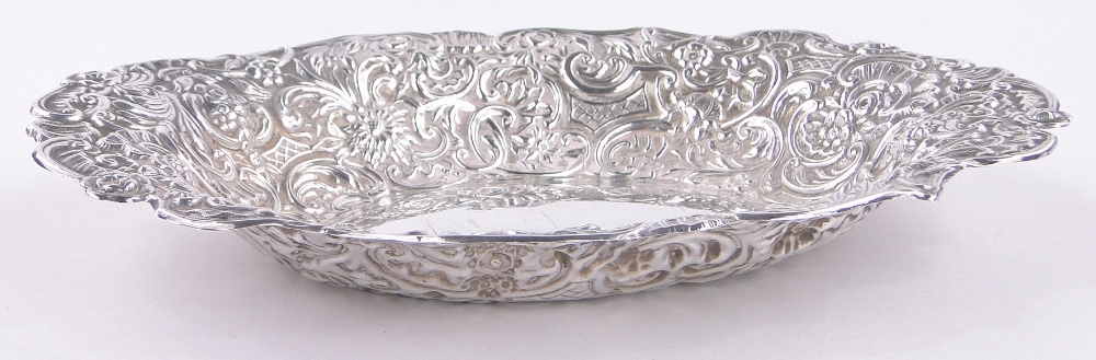 A Victorian oval silver bowl, with relief decorated flowers and scrolls by William Comyns, - Image 2 of 3