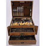A canteen of early 20th century plated cutlery for 12 people, in fitted oak cabinet.