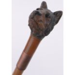 An unusual carved and painted wood tiger head design walking stick, with inset glass eyes.