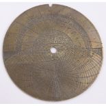 An 18th century Persian brass astrolabe plate, with engraved charts and text,