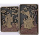 A pair of Chinese relief carved and painted wood wall panels circa 1900, largest height 41cm.