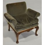 A French stylised armchair, in green velvet upholstery raised on shell carved cabriole legs.