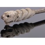 A 19th century club with carved tiger and serpent design bone handle, length 36cm.