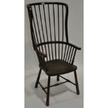 A 19th century country oak stickback Windsor armchair on turned legs.