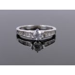 An 18ct white gold solitaire diamond ring, approx 0.3cts, with diamond-set shoulders.