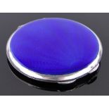 A circular silver and blue enamelled compact, diameter 7.5cm.