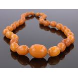 A string of butterscotch amber beads, largest length 23mm, 38g.