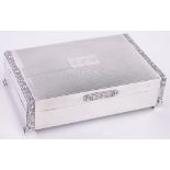 A rectangular silver cigarette box, with Gothic style relief bands, length 13cm.