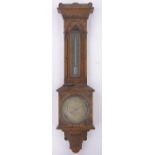 A Victorian carved oak wall barometer and thermometer, by Negretti & Zambra of London, height 72cm.