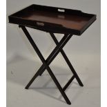 An Antique mahogany butler's tray on folding stand.