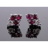 Pair of 14ct white gold 7 stone ruby and diamond earstuds, length 10mm.