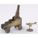 A 19th century bronze table cannon, barrel length 16.5cm on brass wheeled carriage.