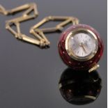 A red enamelled and gilt metal ball shaped pendant watch by Bucherer of Switzerland, diameter 20mm.