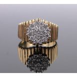 A diamond cluster ring, unmarked gold settings, setting width 10mm, size N.