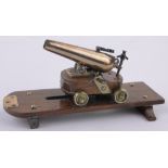 A finely detailed 19th century miniature bronze table cannon, dated 1856 on brass wheeled carriage,