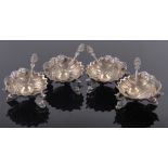 A set of 4 Victorian silver shell shaped table salts, on gurgle fish supports,