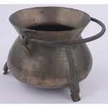 A bronze cauldron, 17th/18th century with flared rim, iron swing handle on 3 feet,