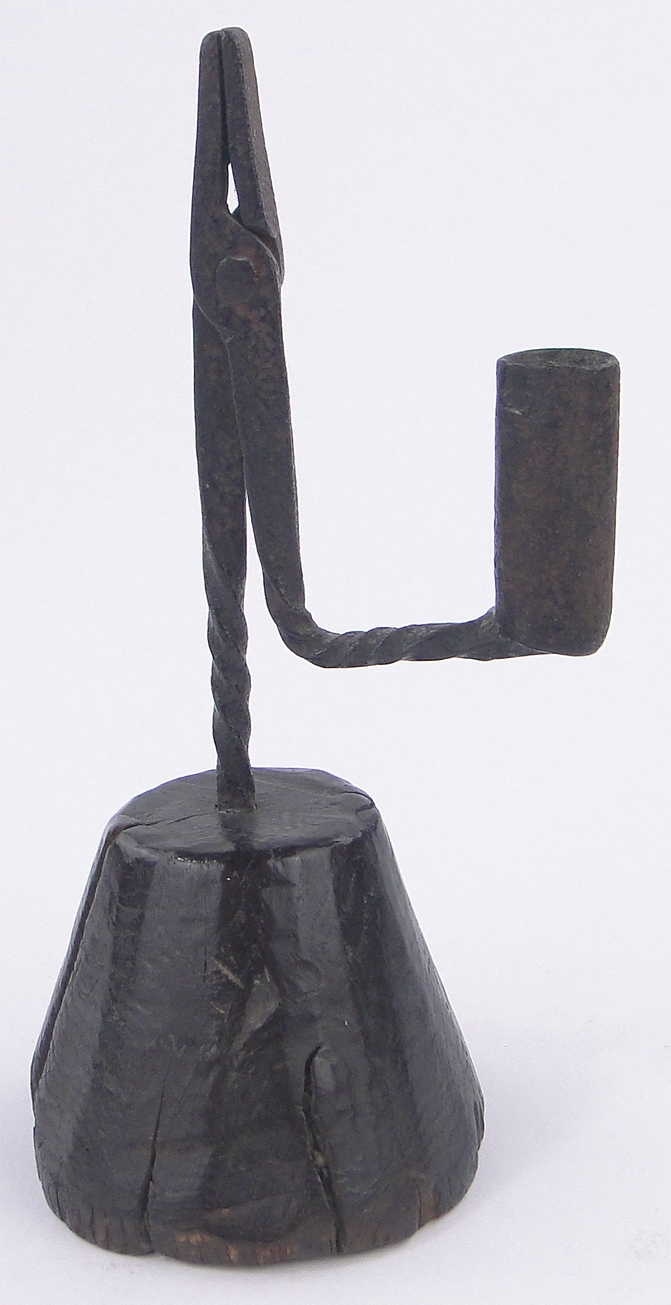 An Antique wrought-iron rush light holder on wooden stand, overall height 22.5cm.