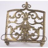 A Victorian cast gilt brass bookstand, 1887, by Adolph Frankau, registered no. 67226, height 20cm.