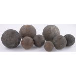 A Collection of 8 early cannon balls, largest 12cm diameter.