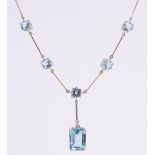 A 9ct gold and blue topaz set necklace, largest stone length 10mm, gross weight 15g.