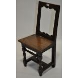 An 18th century joined oak side chair, with carved open back raised on turned legs, height 2'8".