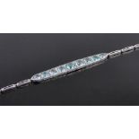 An Art Deco 9 stone graduated blue zircon set bracelet, unmarked white metal settings.