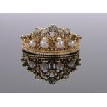 An 18ct gold diamond and pearl set coronet design ring, band width 11mm, size T.