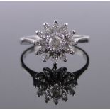 An 18ct white gold diamond cluster ring, total diamond content approx. 0.5cts, size M.