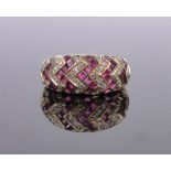 An 18ct gold ruby and diamond set zigzag design band ring, band width 9mm, size M.