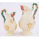 A graduated pair of Clarice Cliff Barbola pattern jugs, with fruit embossed handles,