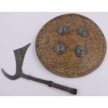 A Middle Eastern leather covered shield, with engraved steel bosses,