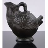 A bronze patinated metal ewer by Just Anderson, in the form of a stylised bird, height 5".