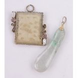 A Chinese carved and pierced jade panel pendant, unmarked setting,