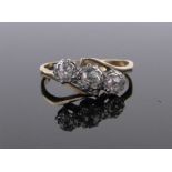 An 18ct gold 3 stone diamond crossover ring, size M.