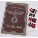A group of German Third Reich items, including Officers pips and an Arbeitsbuch.