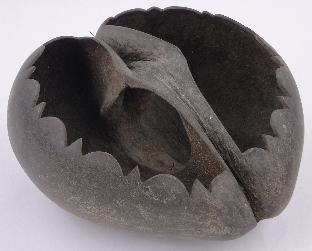 A coco-de-mer nut fruit bowl, early 20th century, with shaped rim, length 30cm.