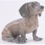 A Royal Copenhagen porcelain seated Dachshund, by Erik Nielsen, length 28cm, height 22cm.