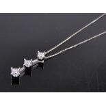 A 14ct white gold 3 stone princess-cut diamond pendant and chain, total diamond content approx.