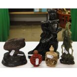 A carved stone musician, and Oriental figures, cinnabar snuff bottle and another, etc.