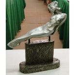 An Art Deco style metal figure of a reclining nude lady on plinth.